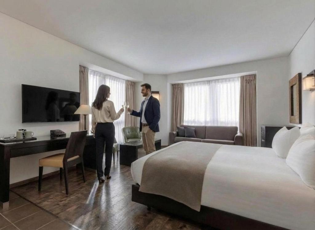 a man and woman shaking hands in a hotel room at Vital - Urban boutique hotel TLV in Tel Aviv
