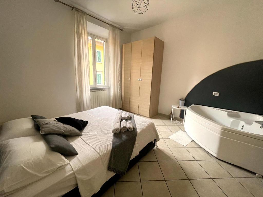 a bedroom with a large bed and a bath tub at Jacuzzi Suite in Livorno