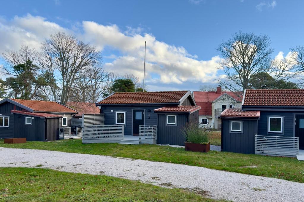 a row of colourful homes in a park at Brissundsbyn in Visby