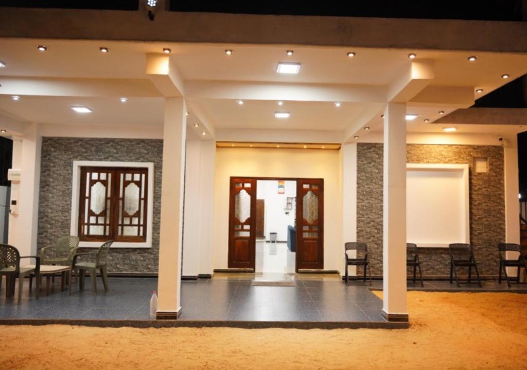 a lobby with chairs and tables in a building at Dilithy Paradise in Trincomalee