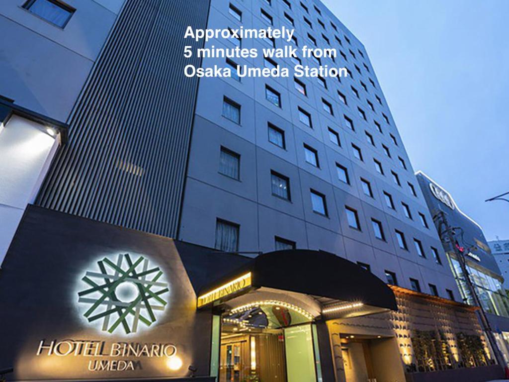 a building with a clock in front of it at Hotel Binario Umeda in Osaka