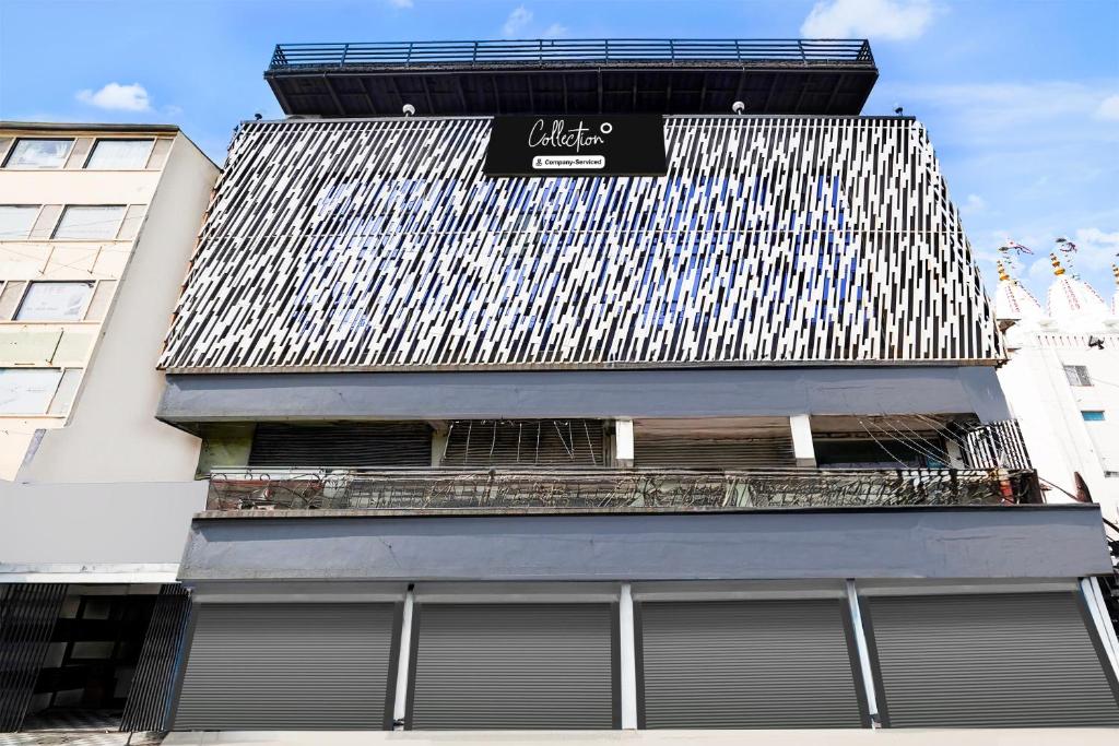 a building with a sign on the side of it at Super Collection O Maninagar Formerly Park Land in Ahmedabad