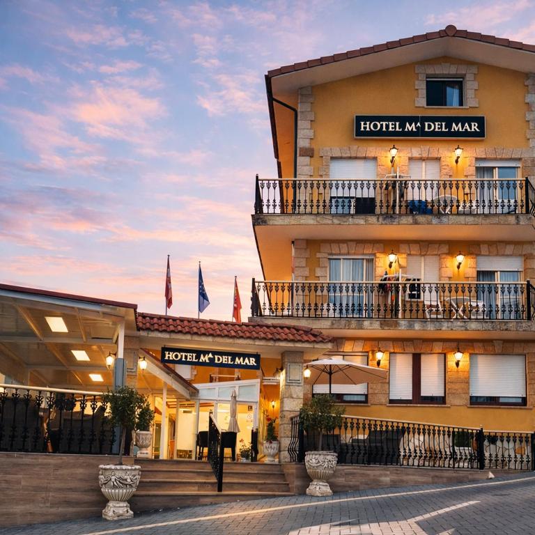 a hotel with two balconies on the side of a building at Hotel Maria del Mar in Noja