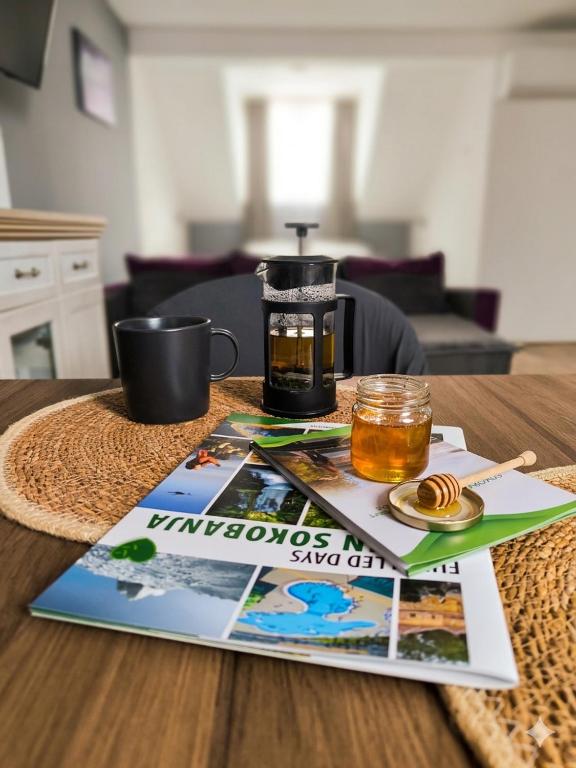 a table with a magazine and a coffee maker on it at Smestaj Dzentlmen in Soko Banja
