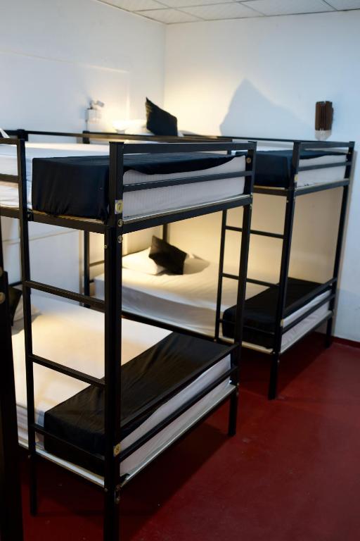 two sets of bunk beds in a room at Secret Surf Hostel in Weligama