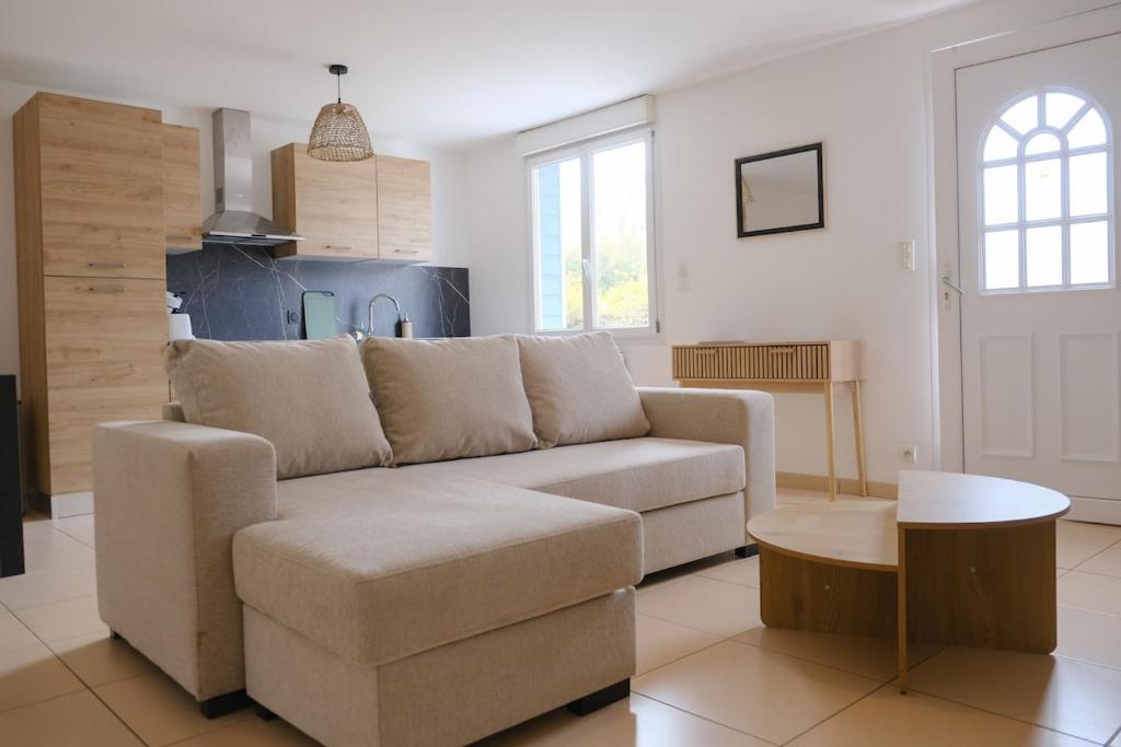 a living room with a couch and a table at Les Embruns, 4 personnes in Criel-sur-Mer