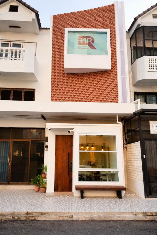 a store front with a door in a building at R4R RoomforRest Boutique Hotel Bangsaen Beach in Ban Laem Thaen