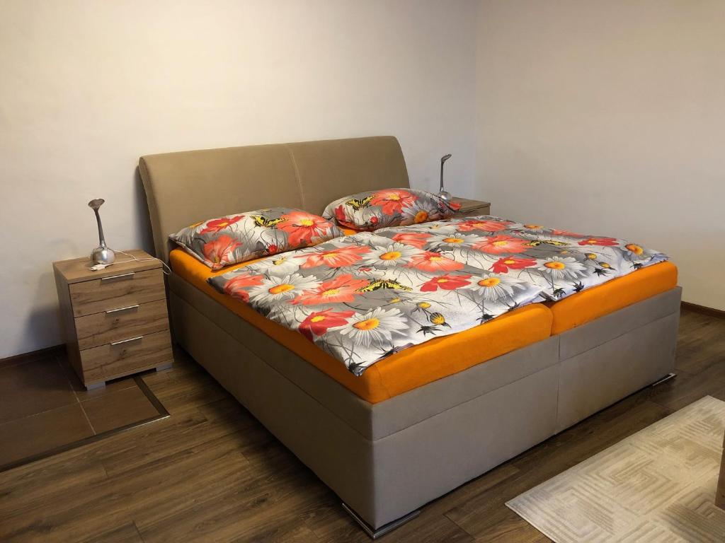 a bedroom with a bed and a night stand at Bibina in Levoča