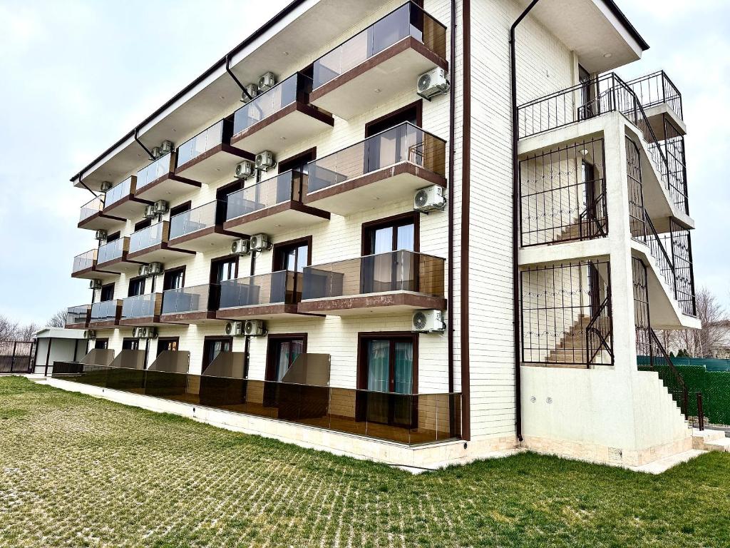 a building with balconies on the side of it at Senin Vama Veche in Vama Veche