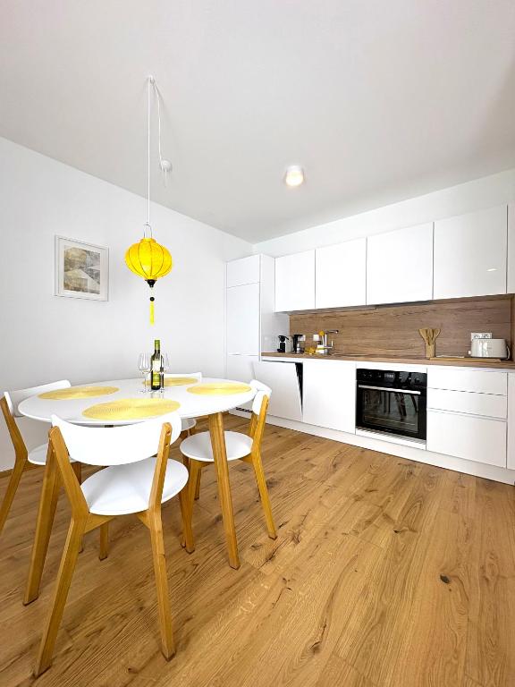 a kitchen with a table and chairs in a room at Seelavie in Podersdorf am See