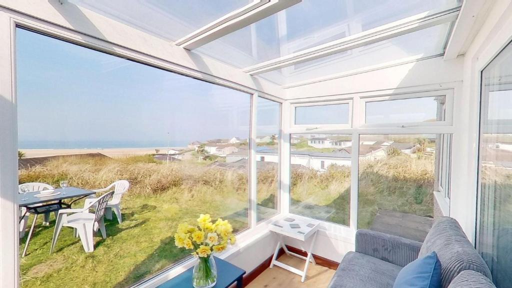 a living room with a view of the ocean at C35 Le Grace, Riviere Towans in Hayle