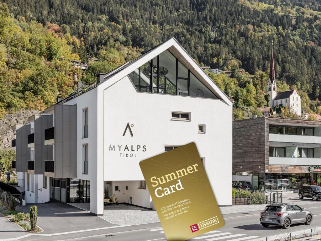 a mykles hotel summer center with a car parked in front at MYALPS Tirol inklusive Sky- Wellness in Oetz