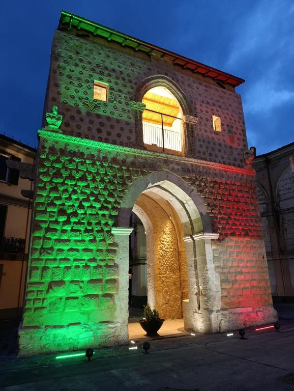 a building is lit up with green and green lights at Porta Napoli Holidays in Sulmona