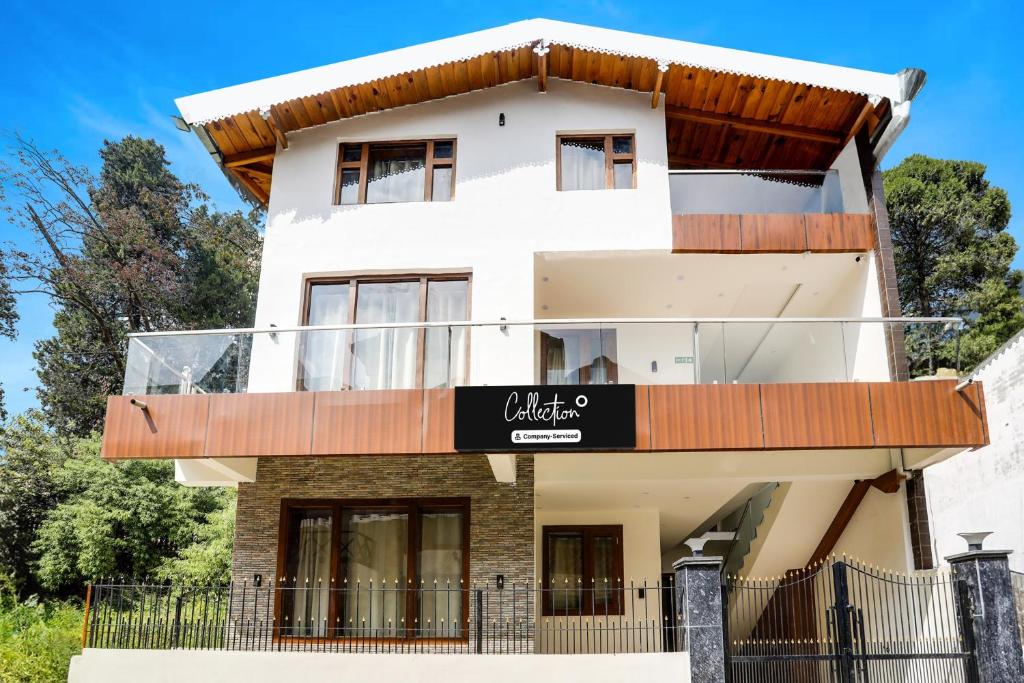 a house with a sign in front of it at Collection O Mall Road Nainital Formerly Urban Bliss in Nainital