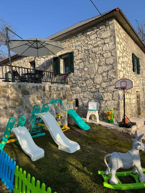 a playground with play equipment in a yard at LOPATE mountain stone house in Lopate
