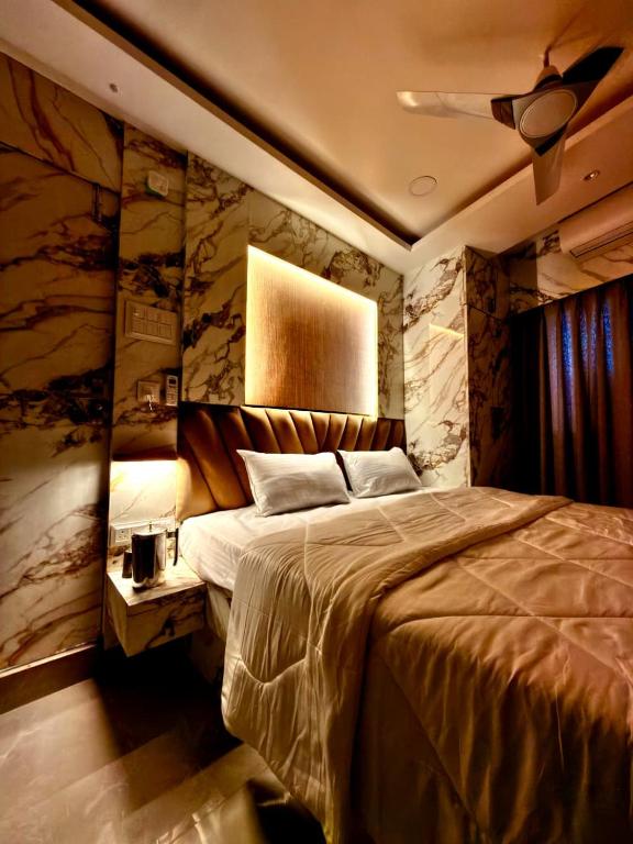 a bedroom with a large bed and a ceiling at Bengal Guest House in Howrah