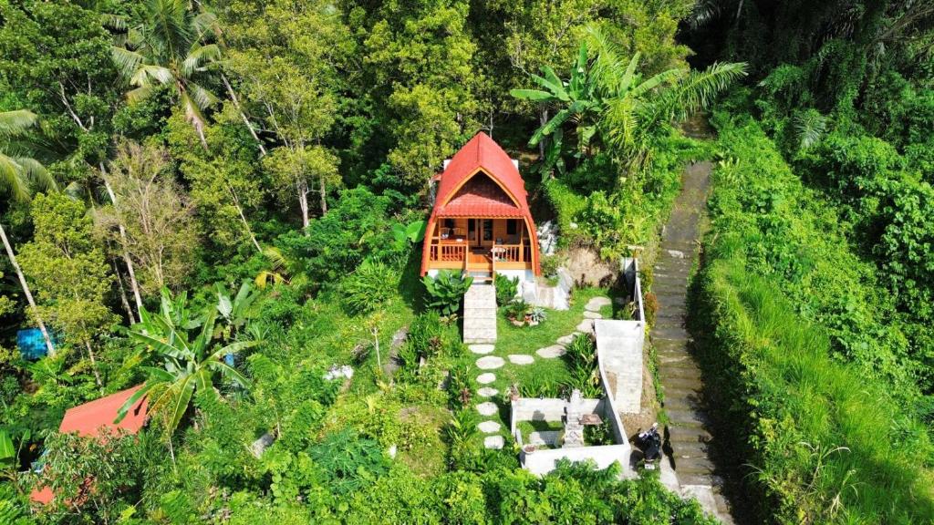 a small building in the middle of a forest at Kastawa Villa in Sidemen
