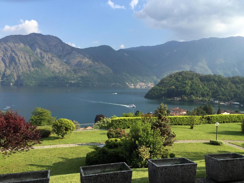 a view of a lake with mountains in the background at Apartment Bella Vista In Mezzegra with POOL sleeps 6- by Italian Apartments in Mezzegra