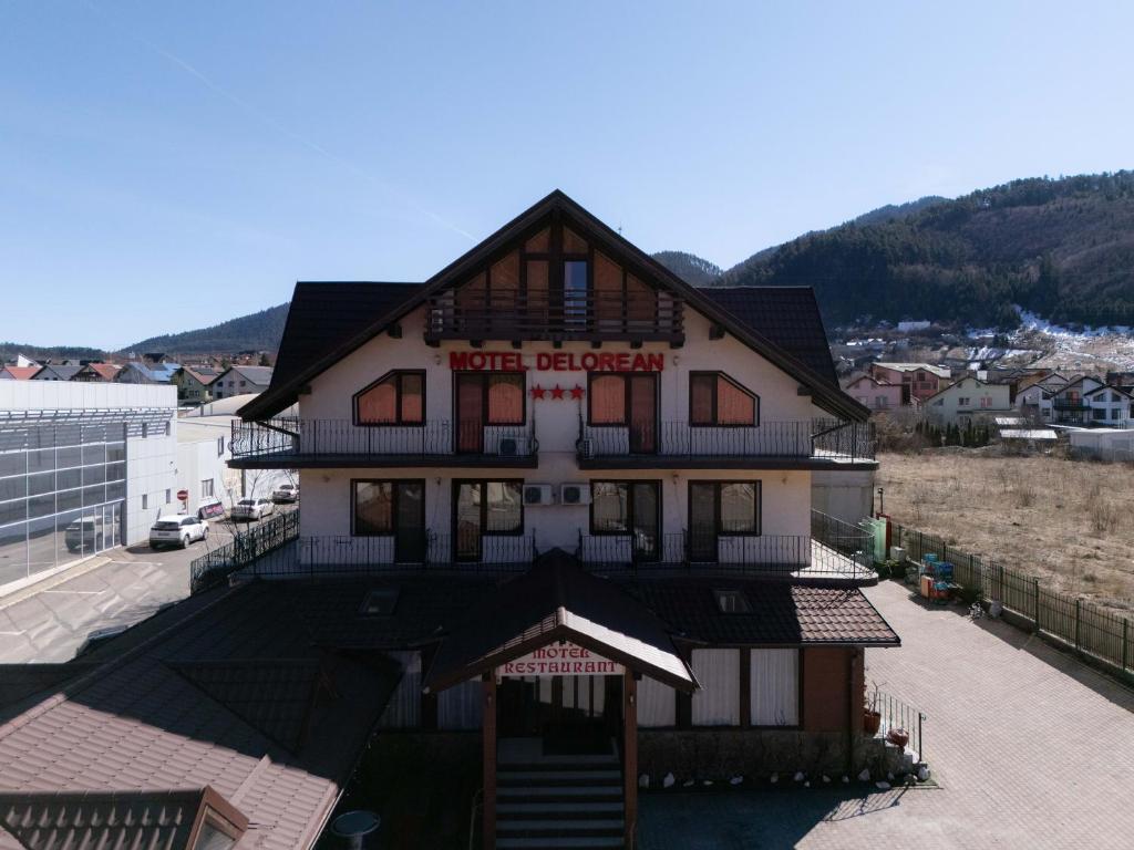 a building with a sign on the side of it at Motel Delorean in Săcele