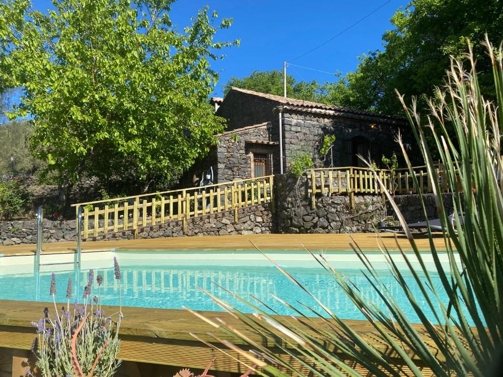 a house with a swimming pool in front of a house at Sicily Private Pool House in Nature in Montargano
