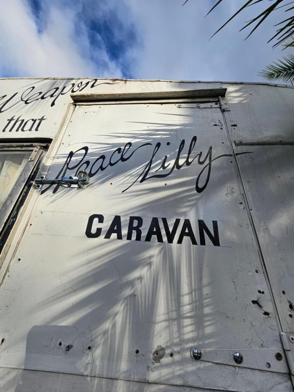 a white building with the words laser utility caravan on it at Ubuntu Backpackers in Umtali