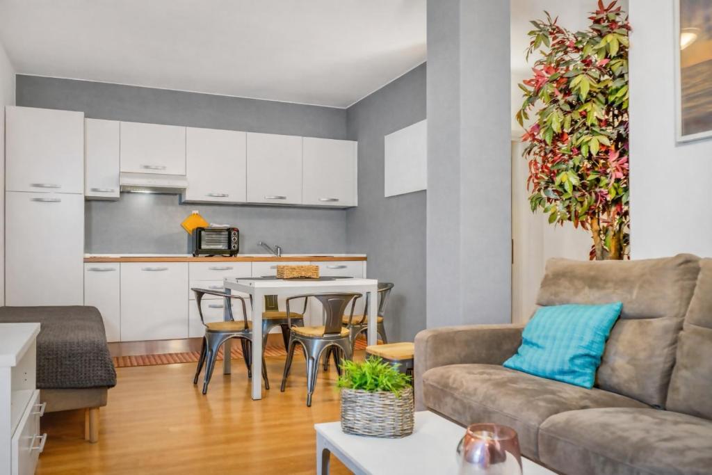 a living room with a couch and a table at Windshouse 2 Apartments in Nago-Torbole