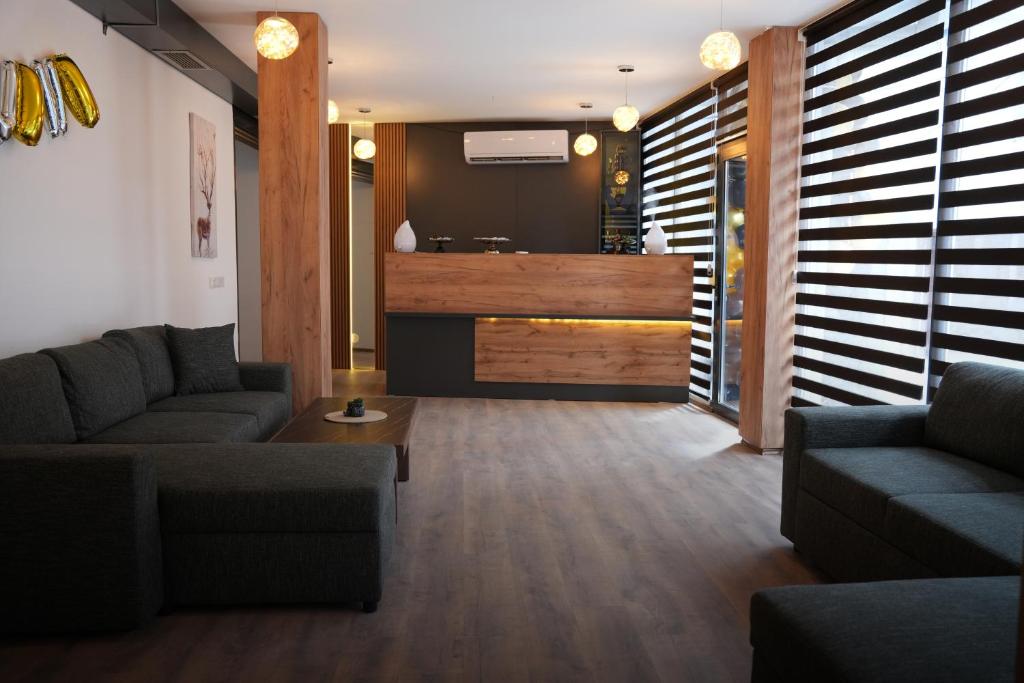 a living room with two couches and a table at Hotel Joana in Prizren