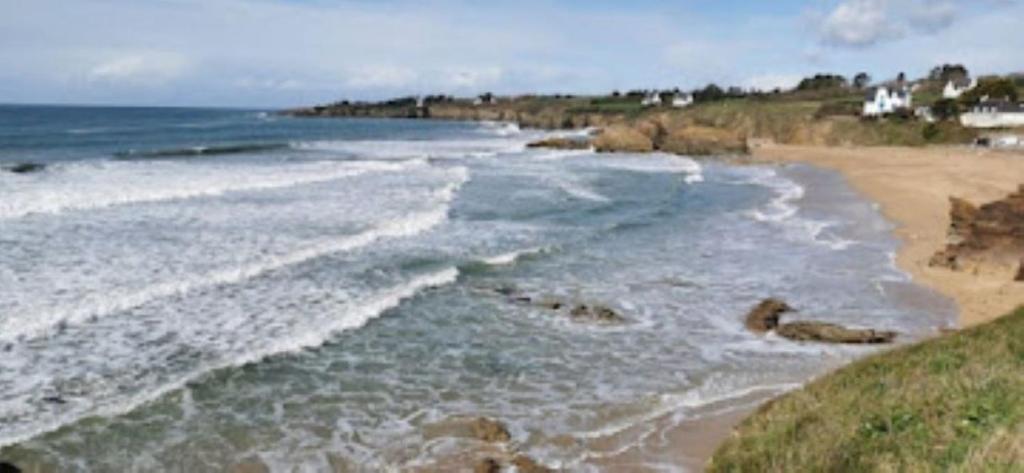 a view of a beach with the ocean at La Belle Vue Piscine chauffée et abritée, vue sur l'océan, plage à pied, bord de mer, BRETAGNE LBC in Clohars-Carnoët