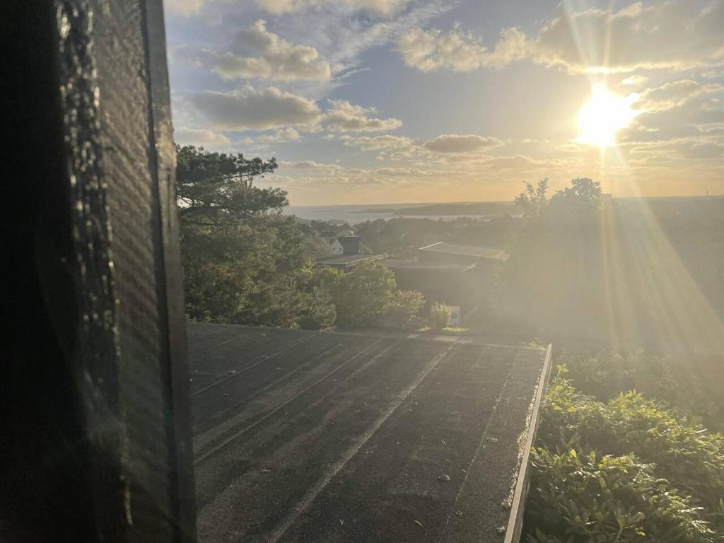 a view of the sun from a roof of a house at Workers Stay - Construction Worker Göteborg in Gothenburg