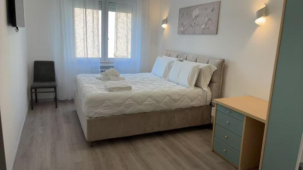 a bedroom with a bed and a chair and a table at Tourgo Venice in Mestre