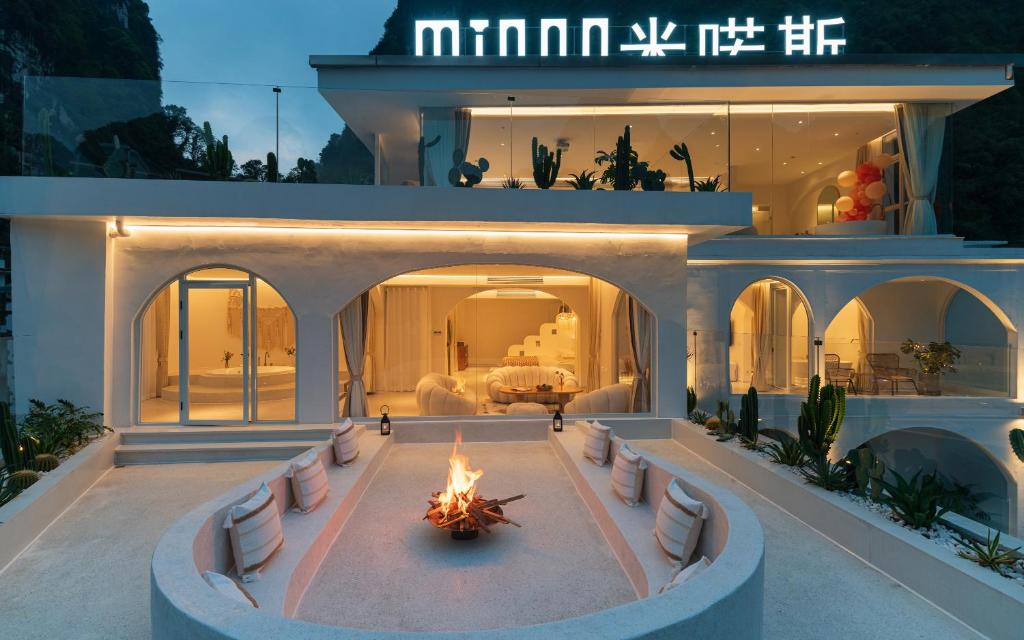 a house with a fire in the middle of a courtyard at Yangshuo MINOS Hotel-Inspired by Santorini design, Entrance of Ten-Mile Gallery,Free Laundry,Itinerary Hepler,Book Tickets in Advance,E Scooter Service in Yangshuo