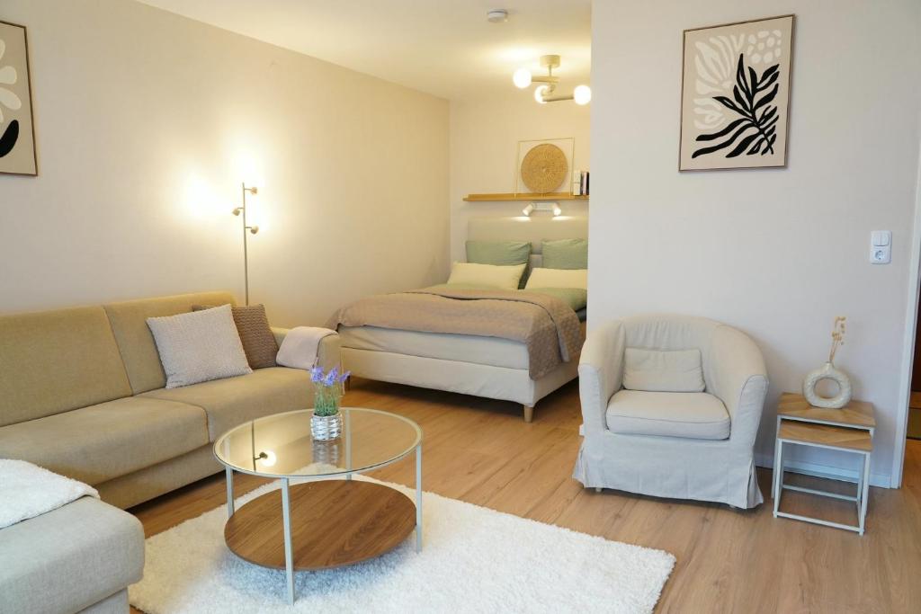 a living room with a couch and a bed at Suite Home Reichenhall in Bad Reichenhall
