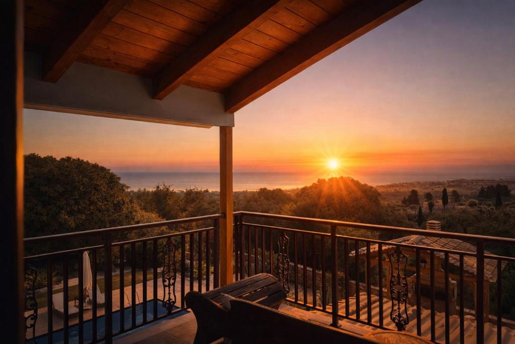a view of a sunset from a balcony at Villa Hestia - Seaview Serenity Villa with Private Pool by Villa Mana Gers in Kypseli