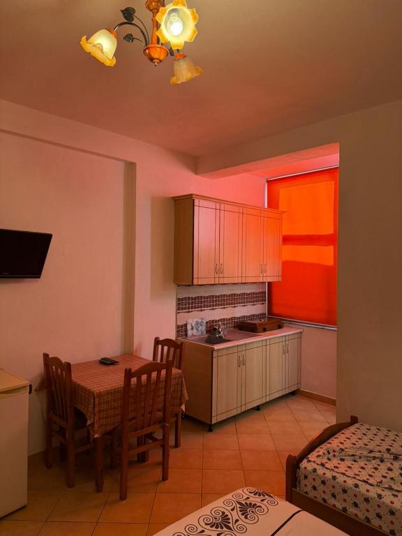 a kitchen with a table and a dining room at Deda Apartaments in Shëngjin