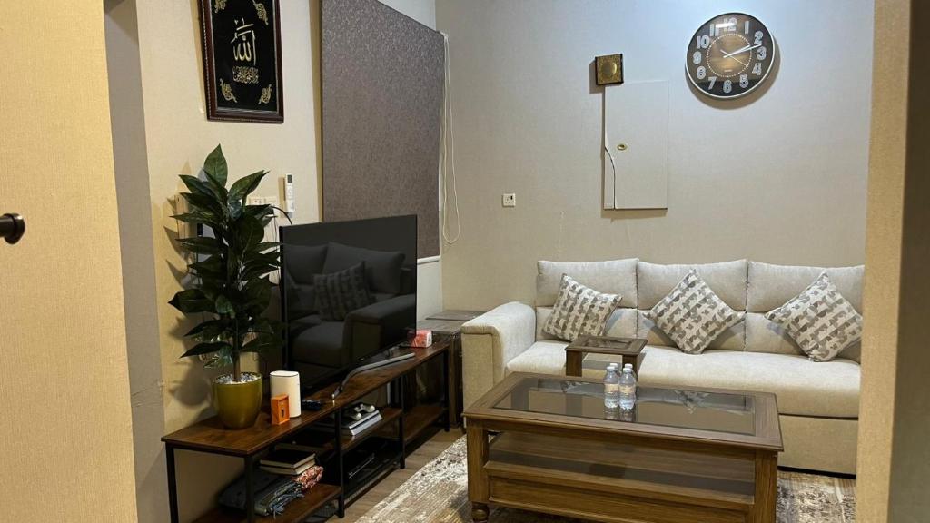 a living room with a couch and a tv at RUBA apartment in Dammam