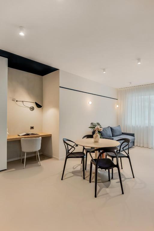 a living room with a table and chairs and a couch at Magnolia Studio Appartamento Marina di Carrara in Marina di Carrara