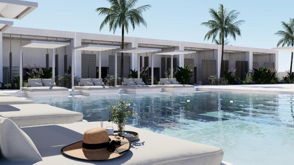 a resort with a swimming pool with white furniture and palm trees at Theretra Pefki Center in Pefki