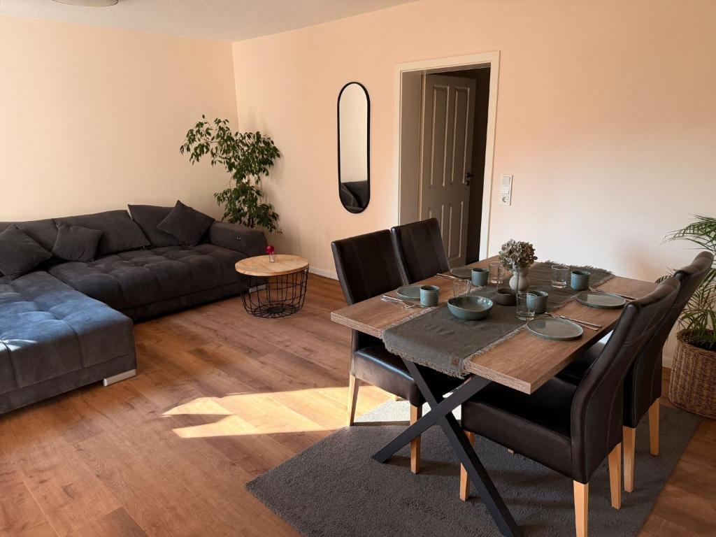 a living room with a table and a couch at Auszeit in Bad Sobernheim
