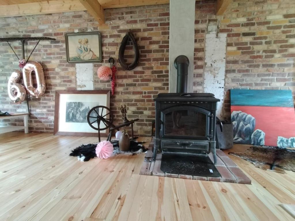 a living room with a fireplace and a brick wall at Bullerbü in Fincken