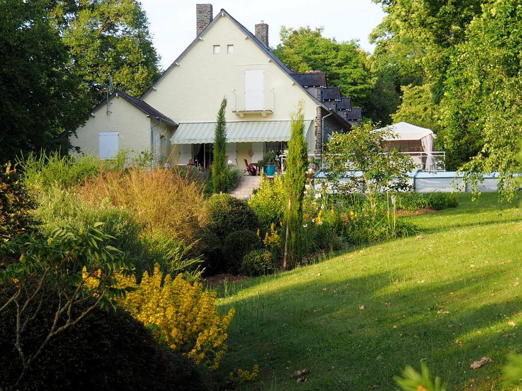a large white house with a garden in front of it at MAISON d HOTES in May-sur-Orne