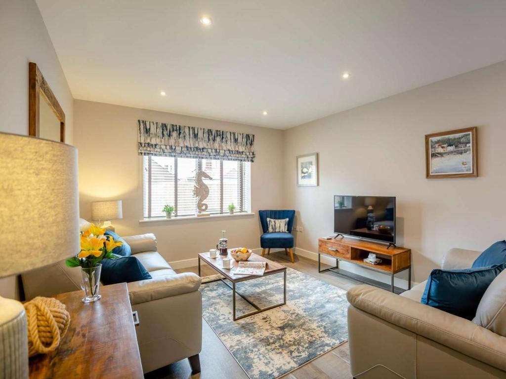 a living room with a couch and a tv at 3 Bed in Seahouses oc-81486 in Seahouses