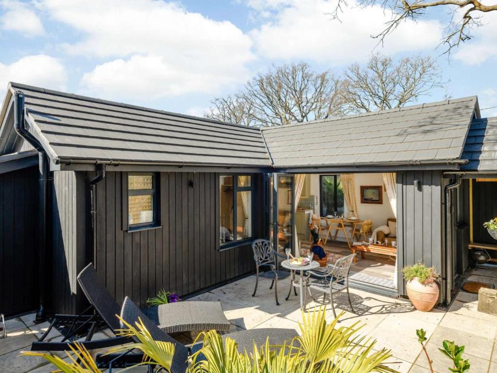 a small house with a pitched roof with a patio at 1 Bed in Wareham oc-87150 in Stoborough