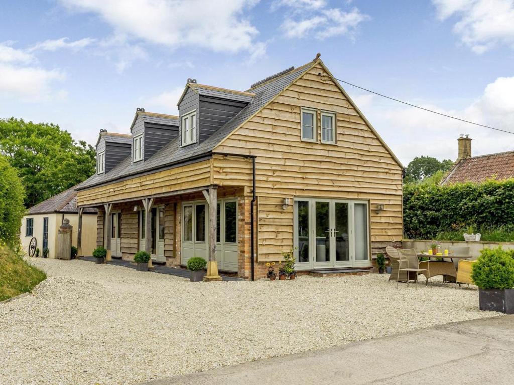 a wooden house with a patio in front of it at 3 Bed in Ilminster oc-77987 in Cudworth