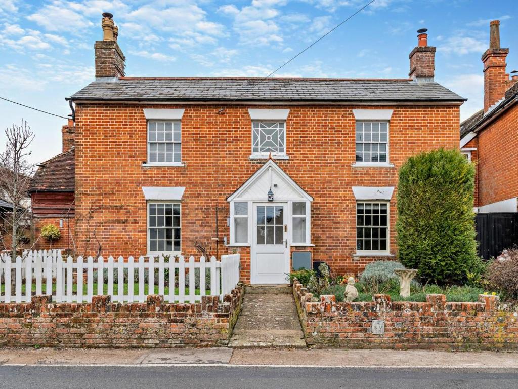 a red brick house with a white fence at 3 Bed in Stockbridge oc-94143 in Broughton