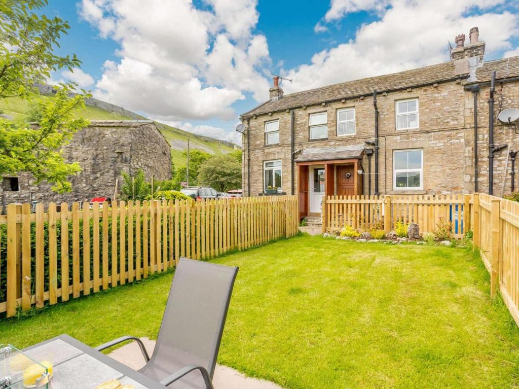 a home with a wooden fence and a yard at 2 Bed in Skipton oc-87370 in Kettlewell