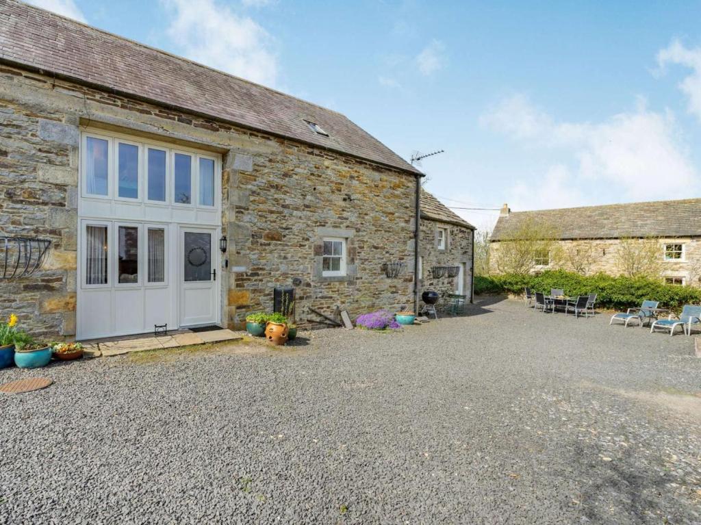 a stone house with a courtyard in front of it at 4 Bed in Consett oc-cn108 in Hunstanworth
