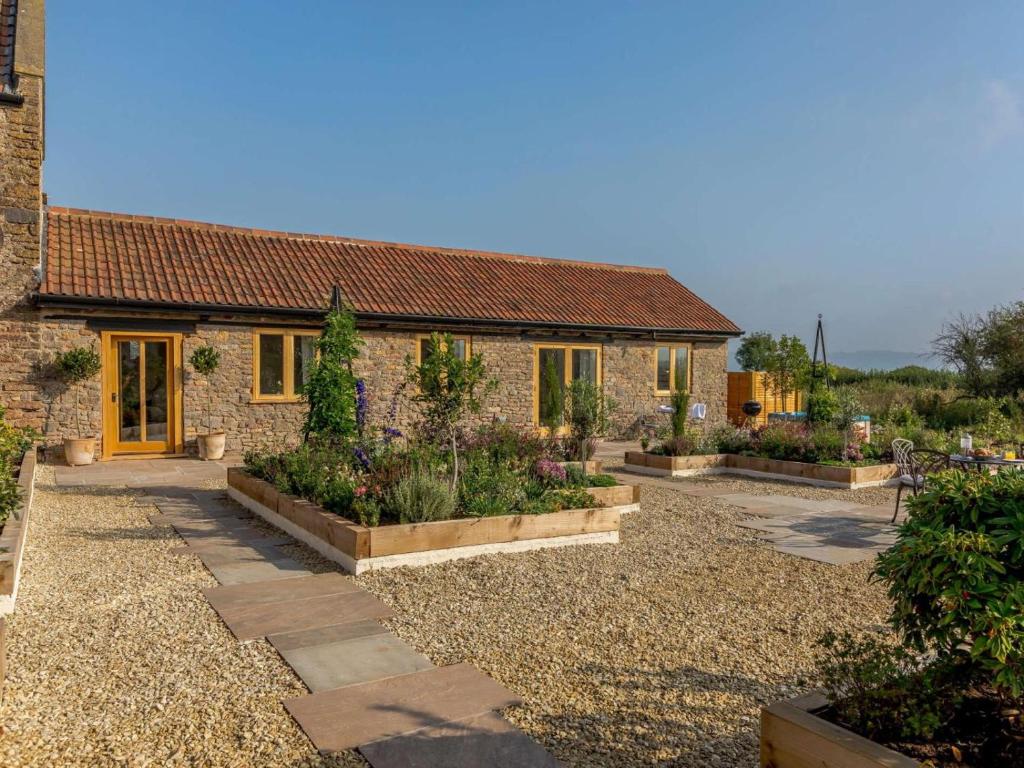 a stone house with a garden in front of it at 1 Bed in Bristol oc-85559 in Langford