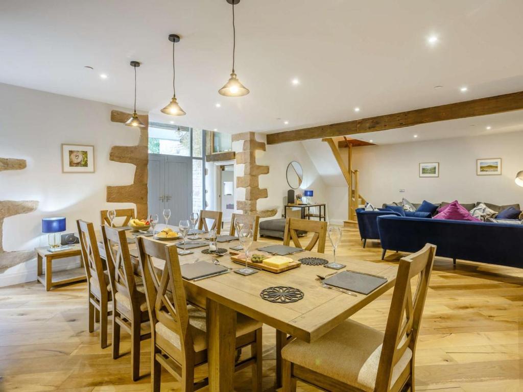 a dining room and living room with a table and chairs at 4 Bed in Skipton oc-84017 in Rylstone