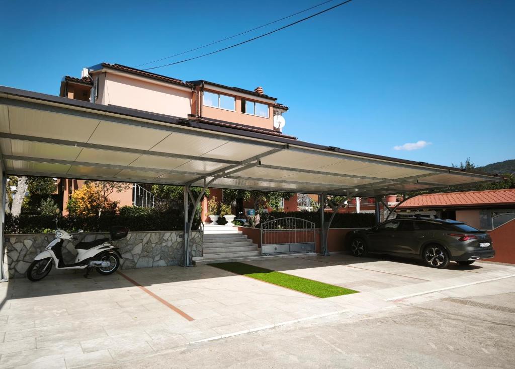 a garage with a car parked under a building at Apartments Vodaric in Cres