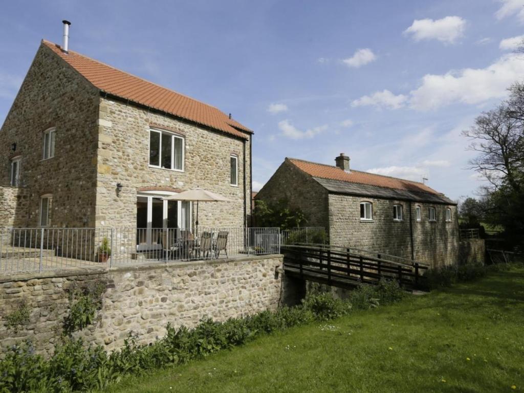 a brick building with a table and chairs in front of it at 3 Bed in Bedale oc-g0095 in Crakehall